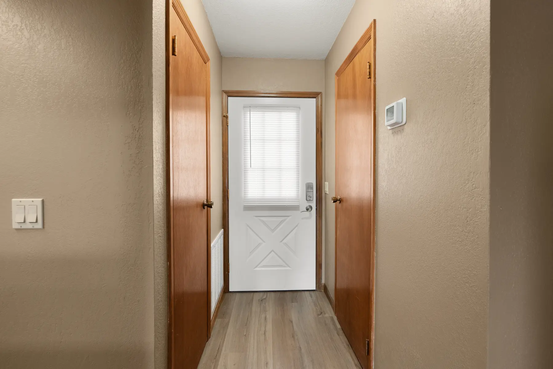 Entry hallway with updated flooring in Unit 101