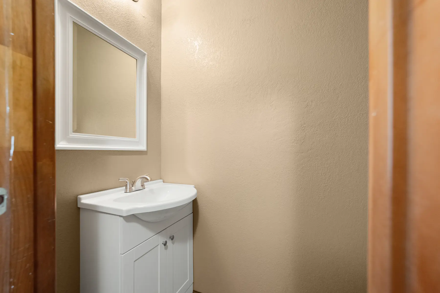 Main-level half bathroom vanity in Unit 101