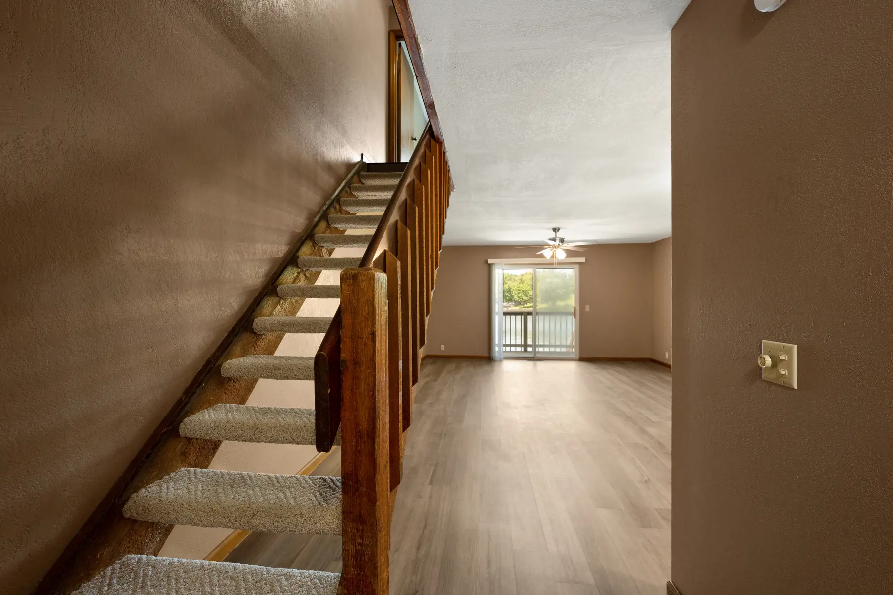 Staircase and lake-facing living room in Unit 101