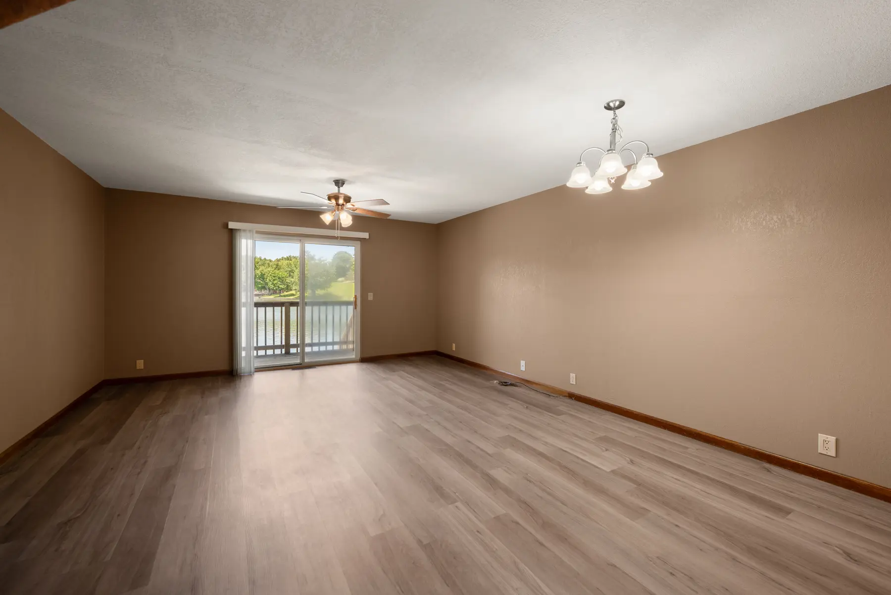 Updated living and dining room with lake-facing doors in Unit 101