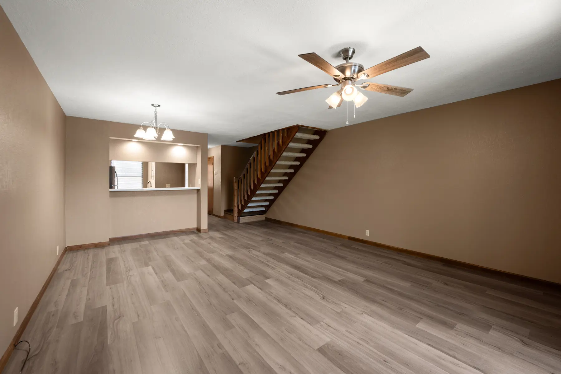 Updated open living room with staircase in Unit 101
