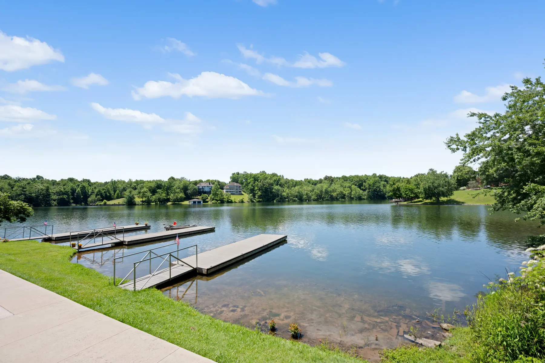 Shared dock and shoreline behind 176 Pointe Landing Unit 101