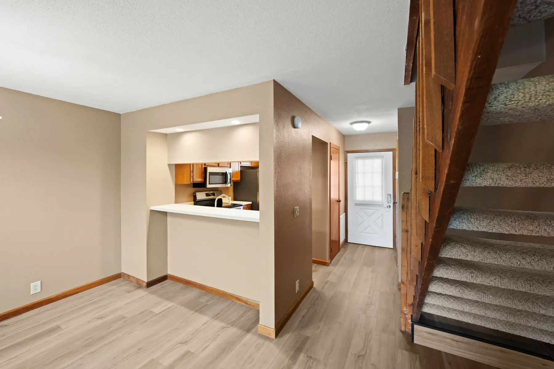 Living room and kitchen pass-through in Unit 101