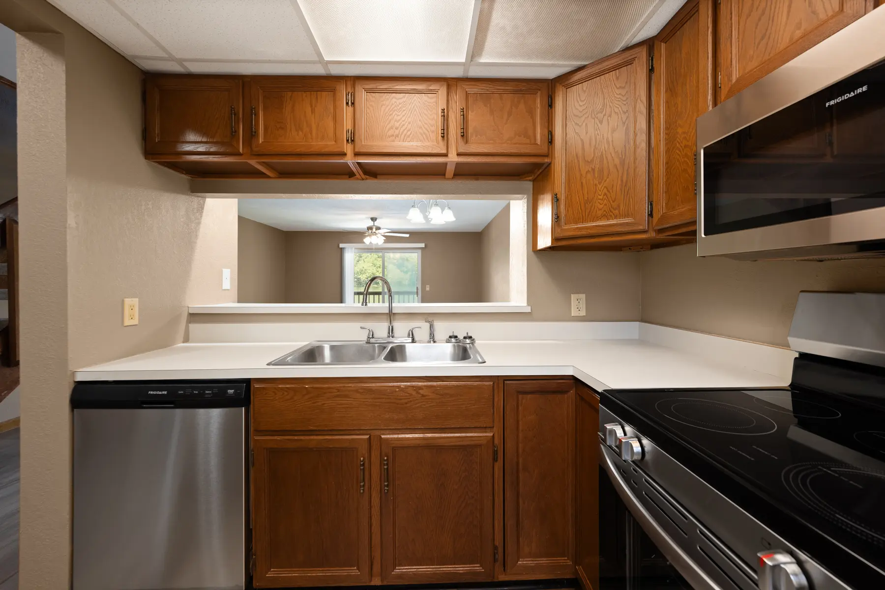 Kitchen sink and wood cabinets in Unit 101