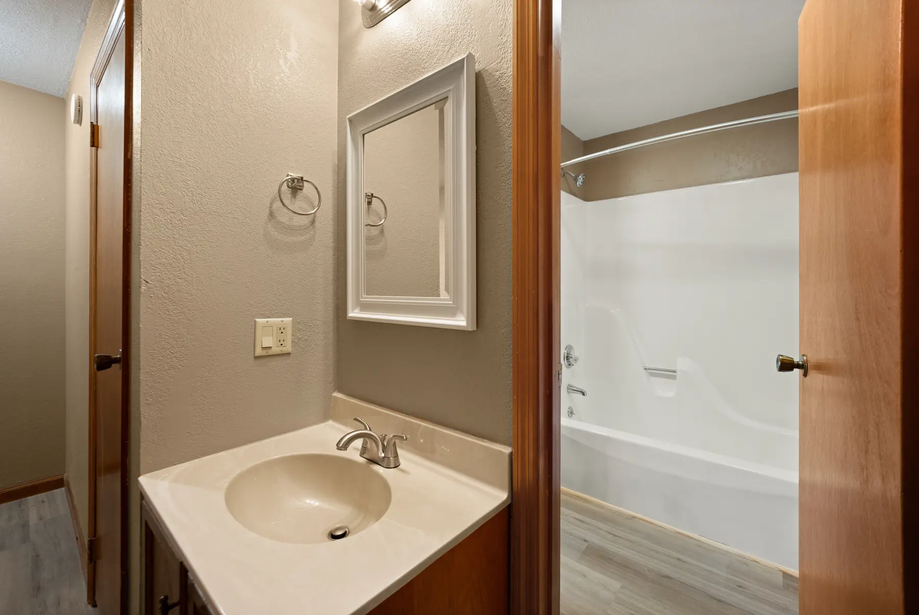 Full bathroom vanity and updated flooring in Unit 101