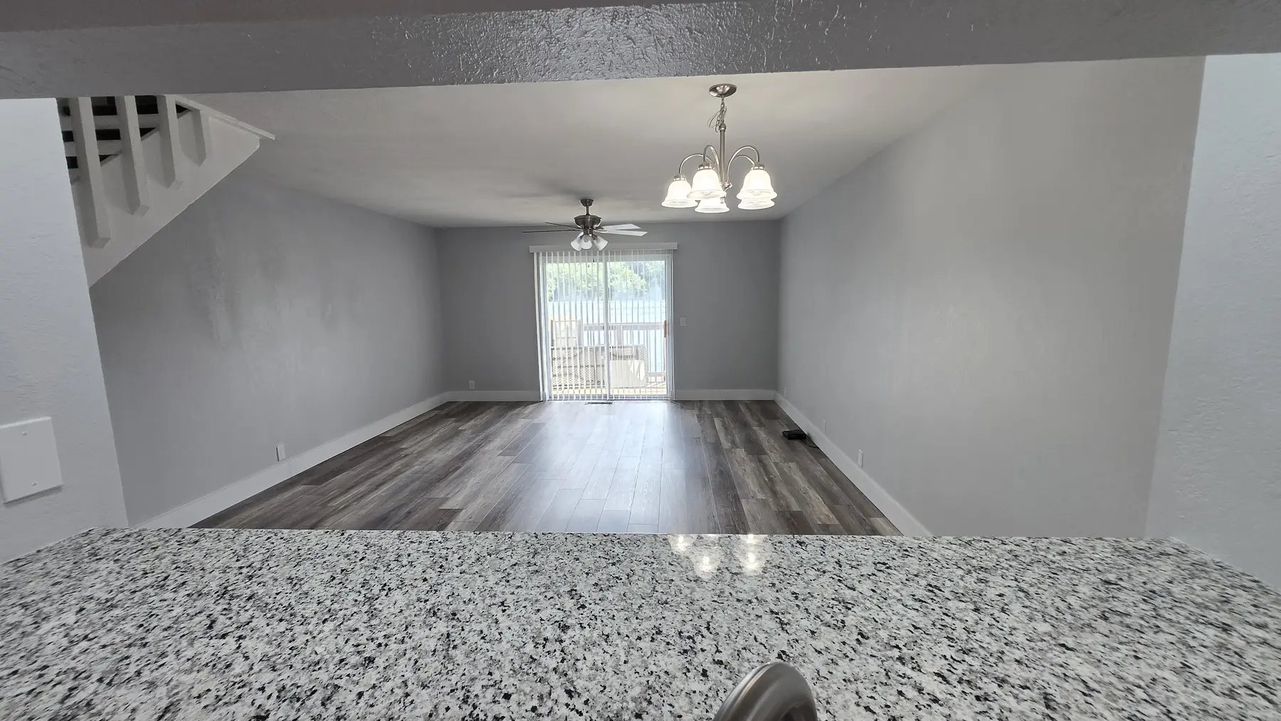 Granite breakfast bar overlooking the living and dining area in Unit 103