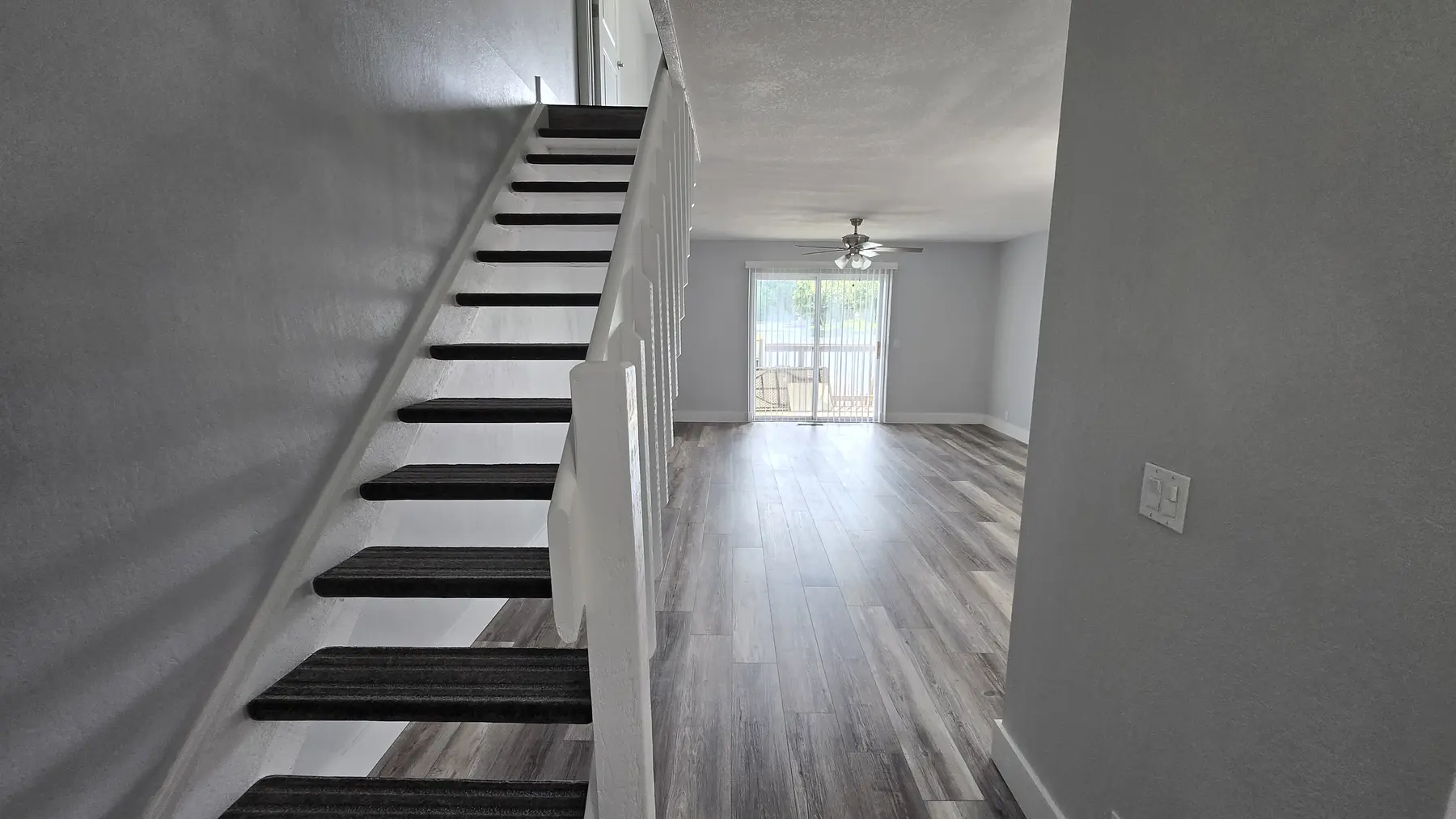 Staircase and lake-facing living area in Unit 103