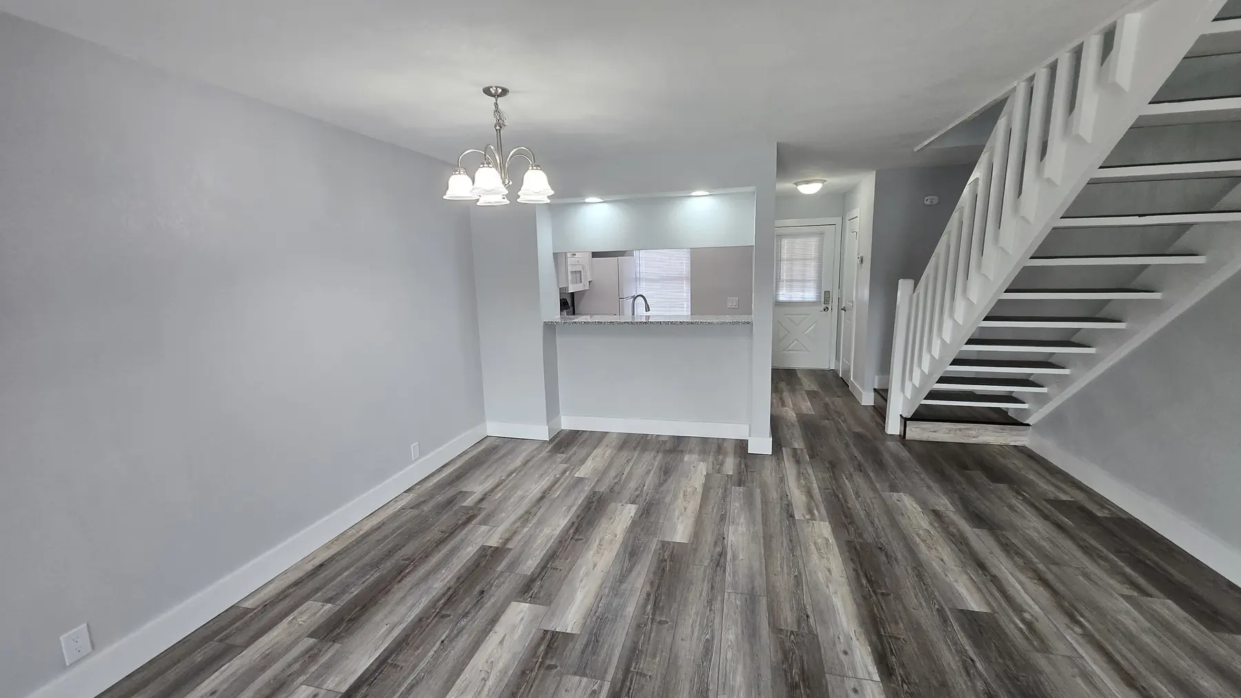 Open living room and renovated kitchen in Unit 103