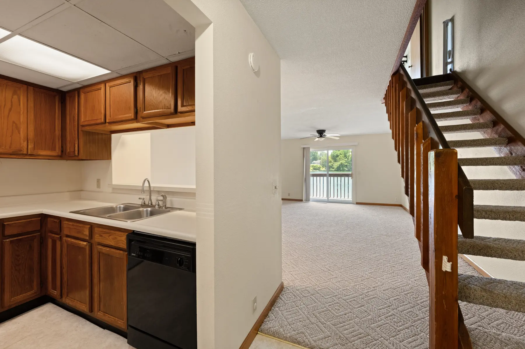 Kitchen and staircase viewed from the main living area in Unit 102