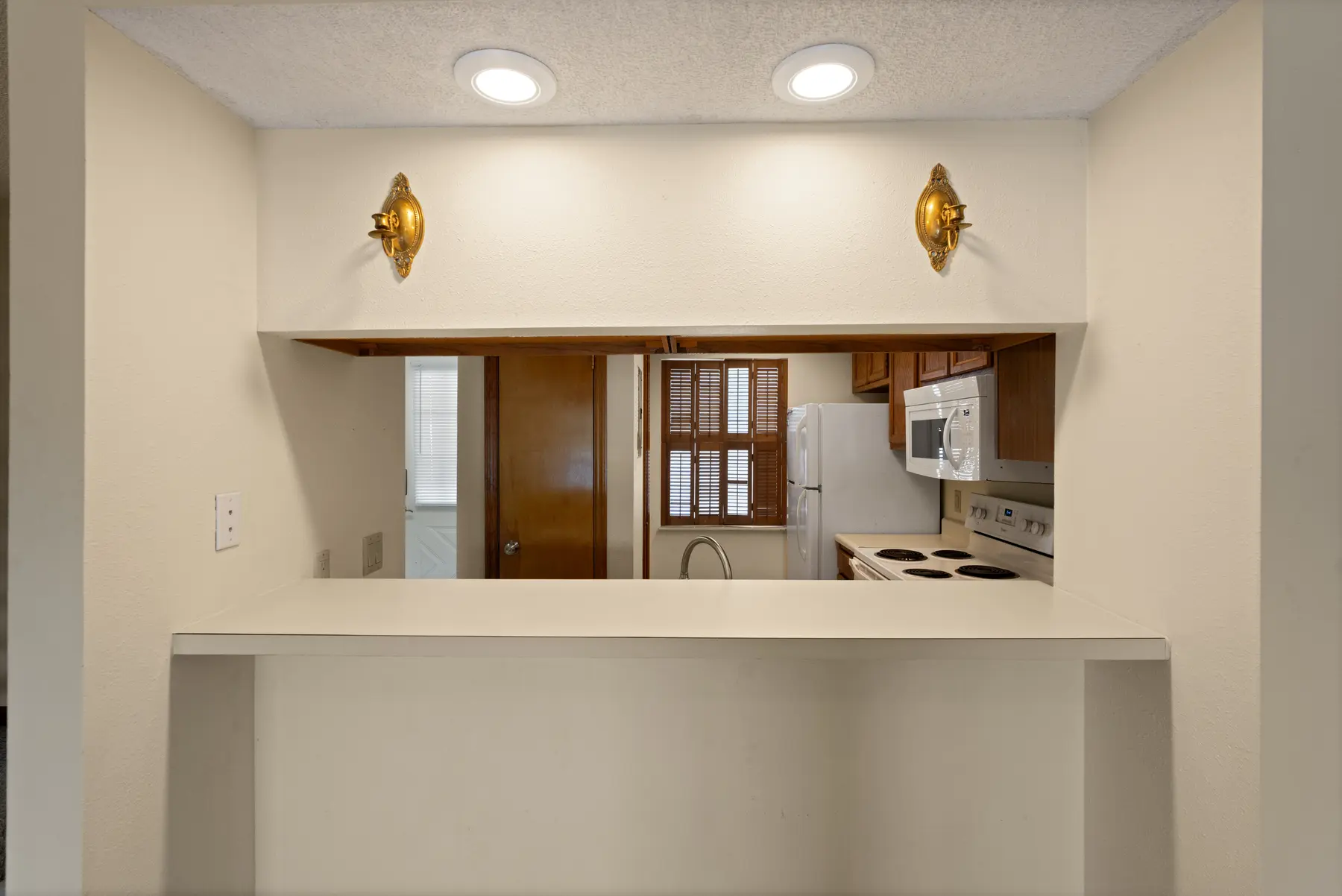 Dining pass-through between the living room and kitchen in Unit 102