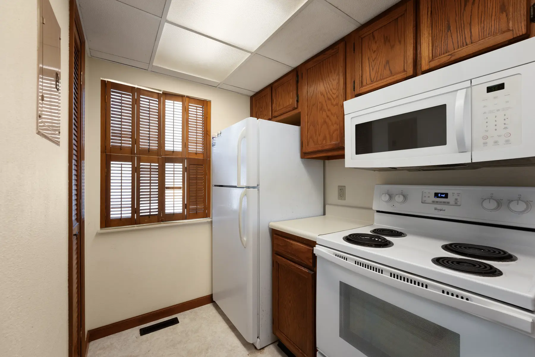 Kitchen with refrigerator, stove, and microwave in Unit 102