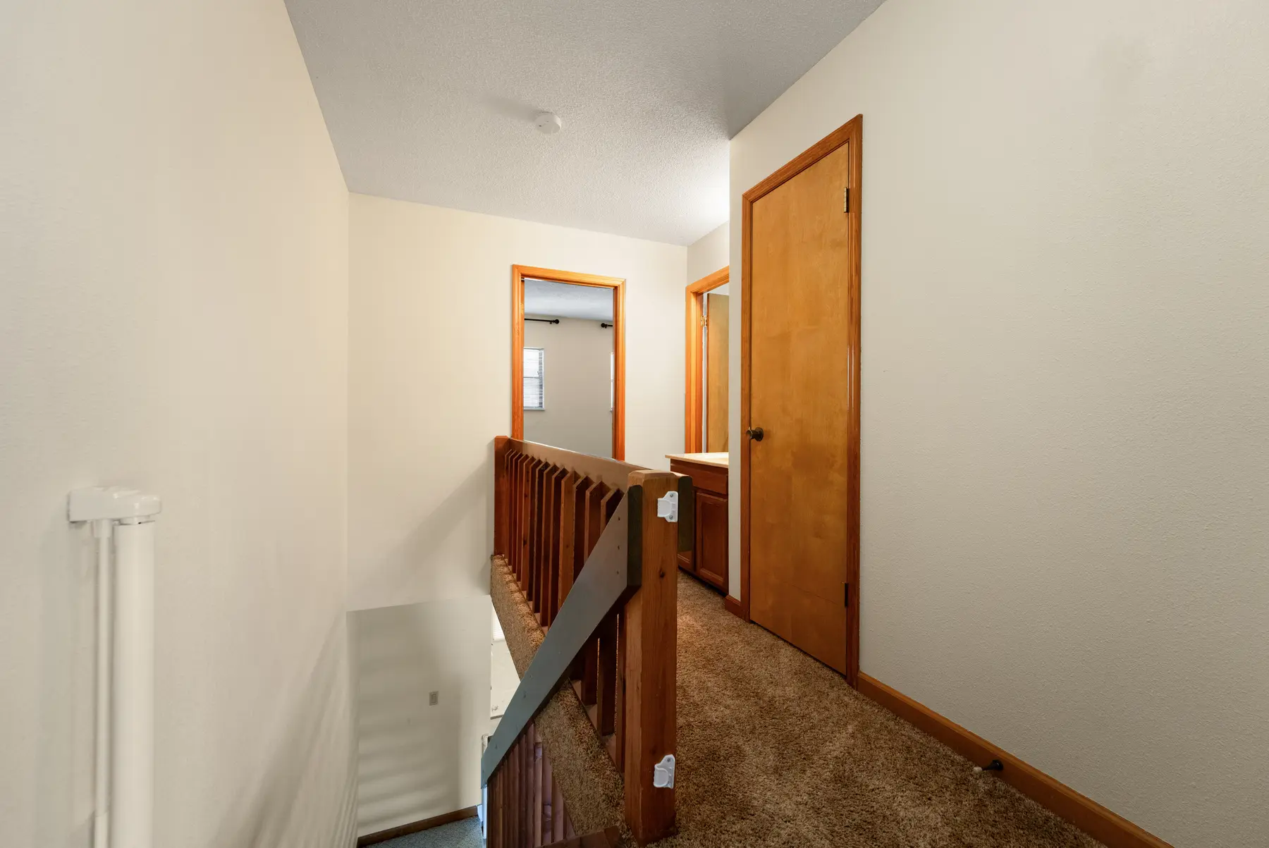 Upstairs hallway and staircase in Unit 102
