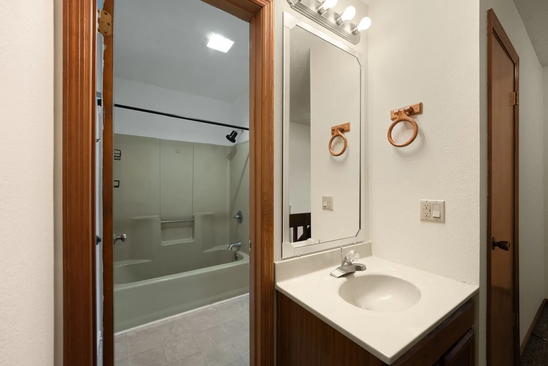 Full bathroom vanity and shower in Unit 102