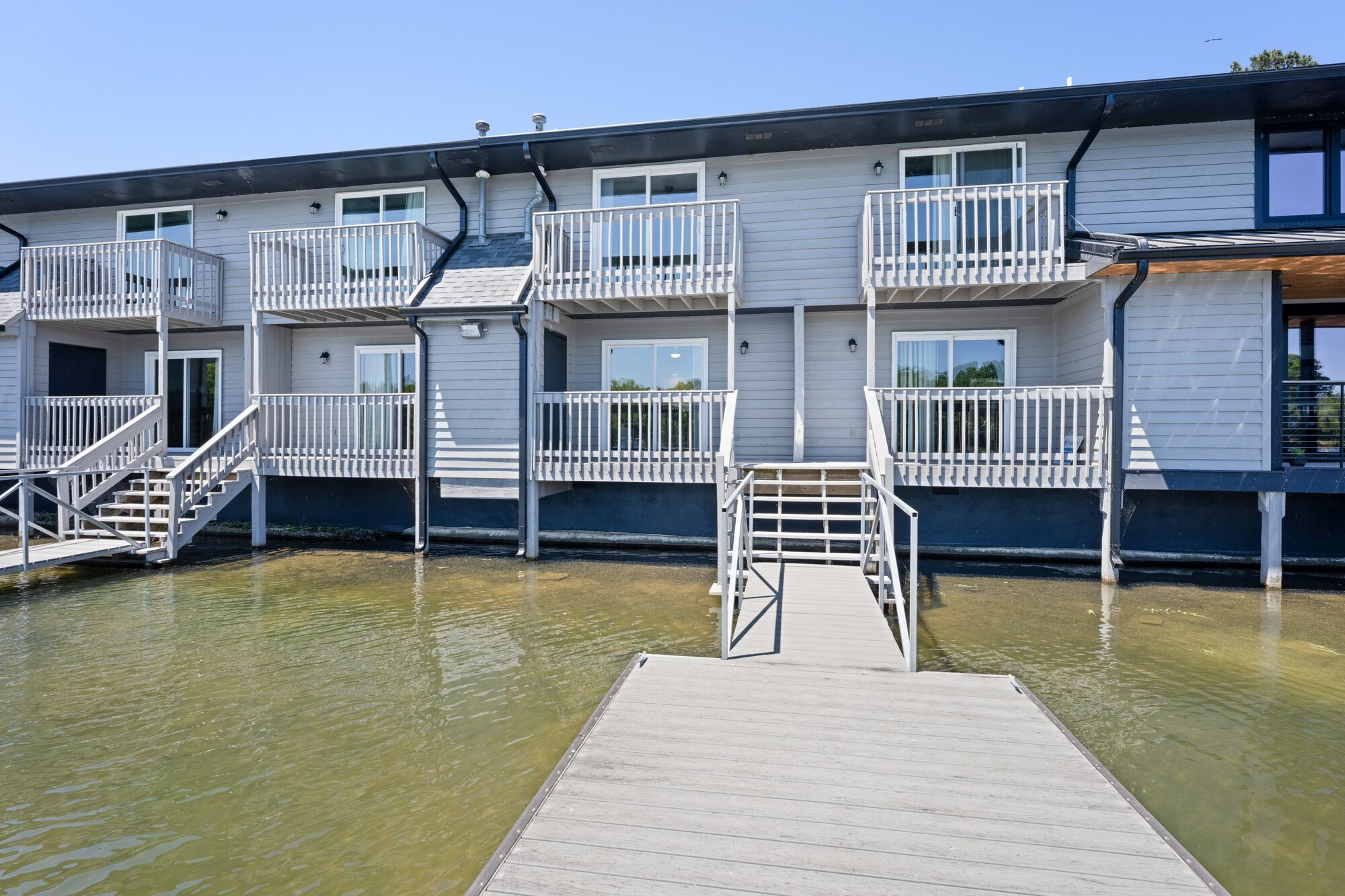 Pointe Landing lakefront exterior with stairs leading directly to the shared dock